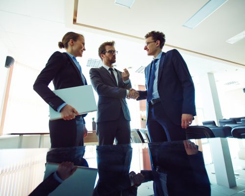 business-partners-shaking-hands-meeting-hall business-partners-shaking-hands-meeting-hall
