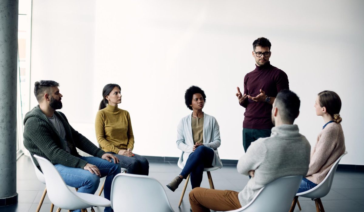 young-man-talking-about-his-problems-during-group-psychotherapy young-man-talking-about-his-problems-during-group-psychotherapy